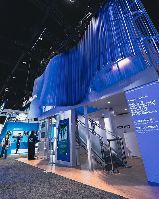 CoreWeave two story exhibit lit in blue at GTC 2026