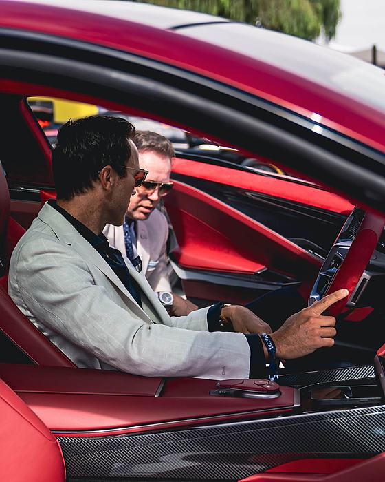 Guests seated in a Karma Automotive vehicle at The Quail